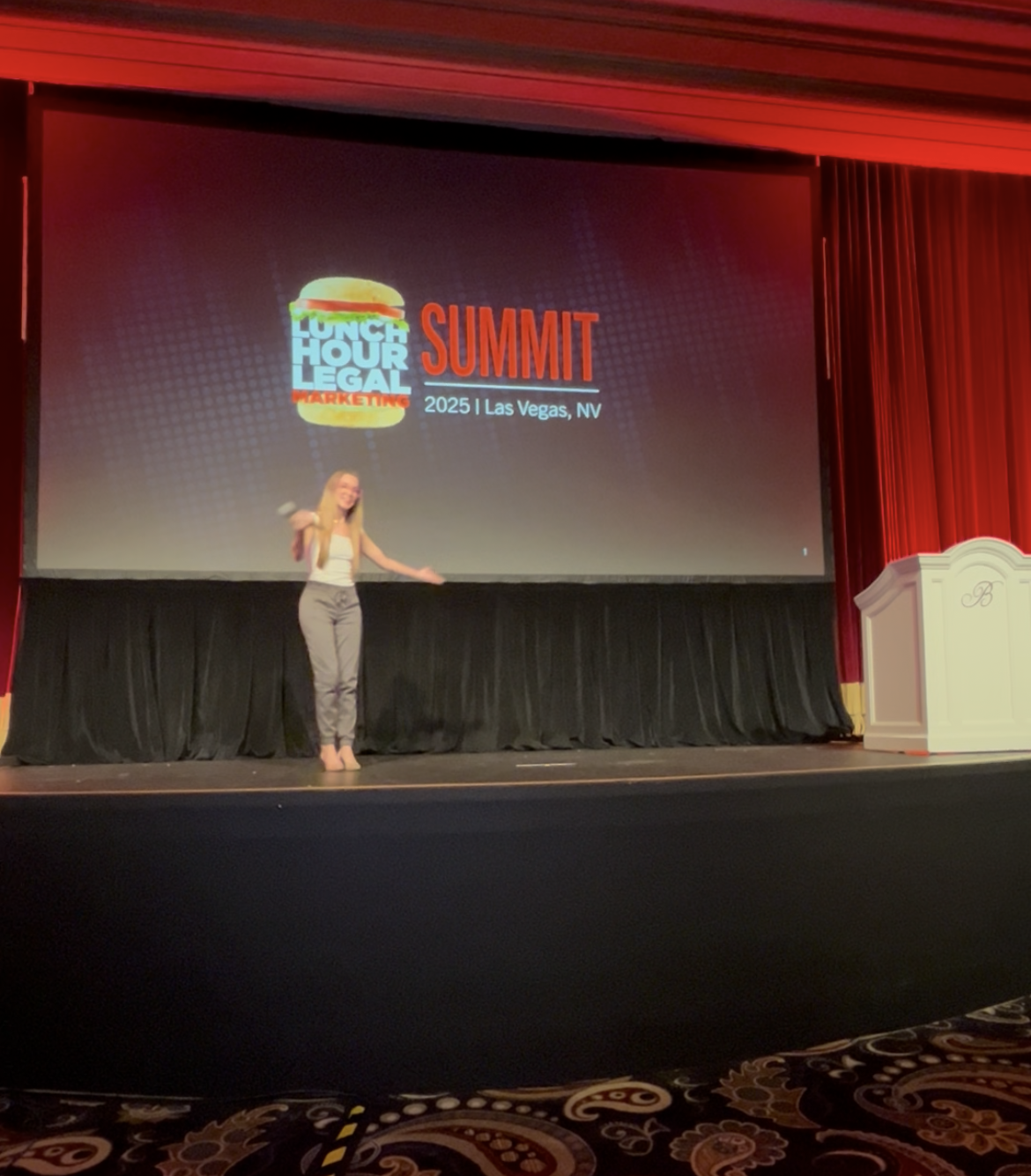 Casey Byrus speaking on stage at the Bellagio during the Lunch Hour Legal Marketing Summit.